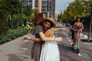 Happy meeting of two friends hugging in the street photo