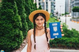 The woman shows her passport to the camera photo