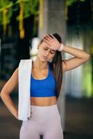 Healthy young female relaxed after training in gym. photo