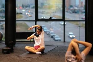 Young sporty woman practicing yoga, working out, wearing sportswear photo