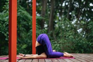 Young beautiful woman doing fitness exercises lying on her back photo