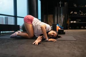 Young woman doing exercises in the gym photo