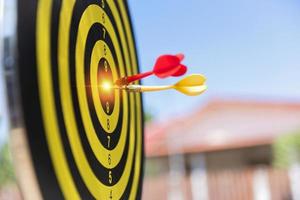 Two dart hit it's target on a red background, concept for success,darts motion blur. photo