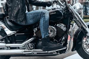 Nothing comes between him and his bike. Close up of man sitting on the motorbike while spending time outdoors photo