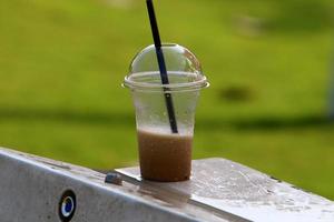 A non-alcoholic soft drink is poured into a glass. photo