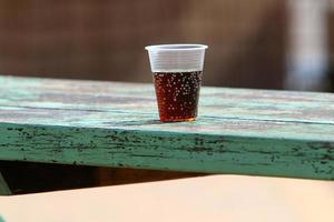 A non-alcoholic soft drink is poured into a glass. photo