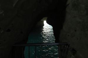 Grottoes in the chalk cliffs on the shores of the Mediterranean Sea. photo