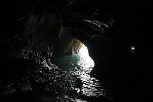 Grottoes in the chalk cliffs on the shores of the Mediterranean Sea. photo