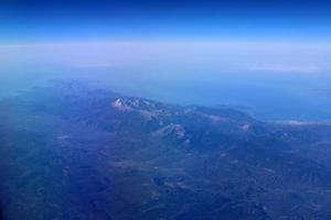 The earth is seen through the porthole of a large jet plane. photo