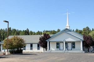 Outside Small Country Church With White Steeple photo