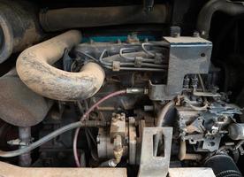 Closeup of the old tractor engine after being used. photo
