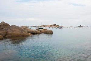 Pink granit coast Beautiful seascape with rocks and clear water. photo