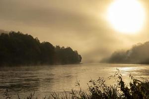 Morning fog on the surface of the river photo