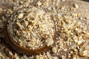 Crushed dried walnuts on the table photo