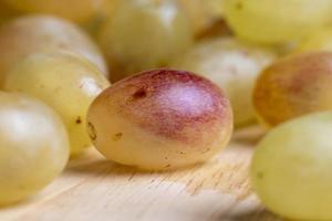 Homemade green unwashed grapes on a board photo