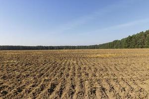 A plowed field with fertile soil for agricultural activities photo