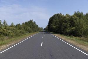 Narrow paved road for cars photo