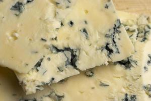 Cheese with blue mold cut into pieces photo