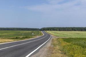 Narrow paved road for cars photo