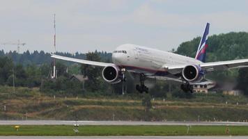 MOSCOW, RUSSIAN FEDERATION JULY 29, 2021 - Boeing 777 Aeroflot arrive at Sheremetyevo International Airport Moscow SVO. Landing and touching an airplane in slow motion video
