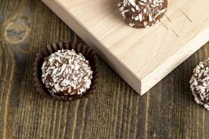 Chocolate candies with coconut flavor and filling photo