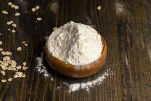 Wheat flour from a wooden bowl photo