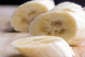 Sliced ripe banana on a cutting board photo