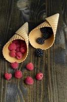 Ripe red raspberries in a crispy waffle cone photo