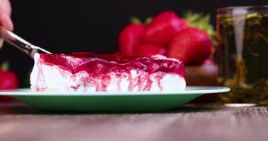 Cut strawberry cake with cheese cream and jam photo