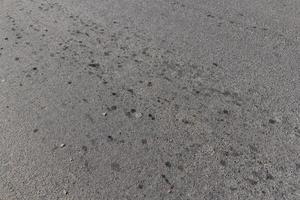 Paved road with engine oil stains photo