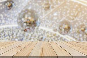 Empty wood table top with blur Christmas tree with bokeh light background photo