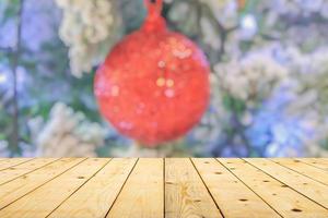 Empty wood table top with blur Christmas tree with bokeh light background photo