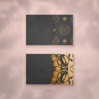 Presentable business card in black with gold mandala ornaments for your brand. vector
