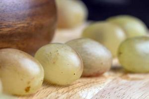 Homemade green unwashed grapes on a board photo