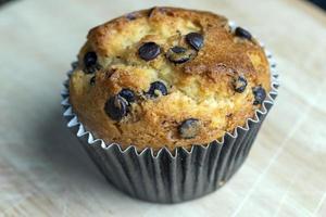 Cupcake with chocolate pieces, close up photo