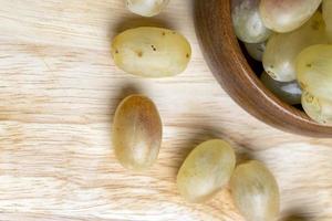 Homemade green unwashed grapes on a board photo