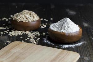 Wheat flour from a wooden bowl photo