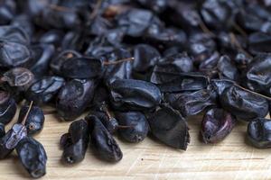 Black spices of dried barberry for cooking meat photo