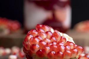 Red pomegranate seeds on the table and the board photo