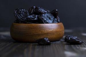 Dried plums on the kitchen table photo