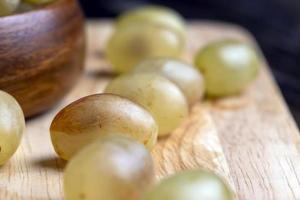 Homemade green unwashed grapes on a board photo