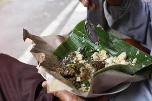 rice with cassava leaves and fried chicken photo