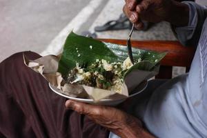 rice with cassava leaves and fried chicken photo