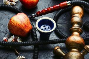 Smoking hookah with apple flavor photo