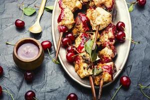 Poultry skewers in cherry sauce photo