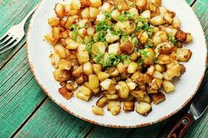 Fried potatoes with green onions photo