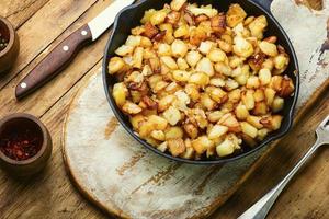 Roasted potatoes in iron skillet photo