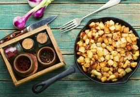 Roasted potatoes in iron skillet photo