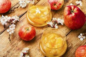 Homemade apple jam and red apples photo