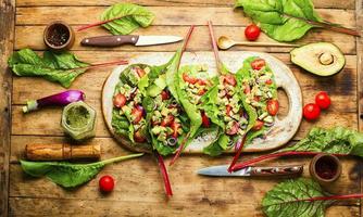 Spring vegetable salad in chard leaves photo